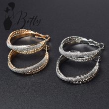 Anyagában mintás és csillámdíszes, karika fülbevaló